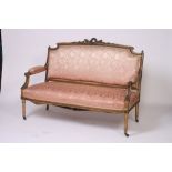 A 19th Century gilt wood salon settee, the cresting rail decorated with garlands,