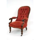 A Victorian mahogany buttoned spoon back armchair, upholstered in pink velour,