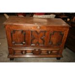 An 18th Century oak mule chest, having hinged lid above a triple moulded panel front,