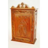 A 19th Century continental carved fruitwood wall cabinet, surmounted by a shaped pediment,