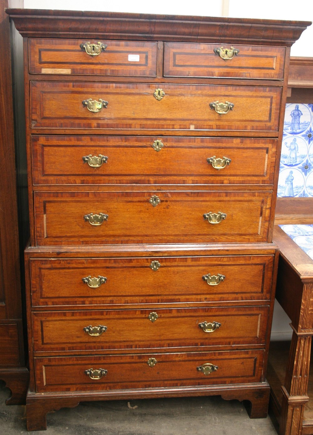 A Georgian oak mahogany strung and cross-banded chest on chest,