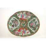 A 19th Century Canton oval dish, decorated in the traditional manner with segment panels of figures,