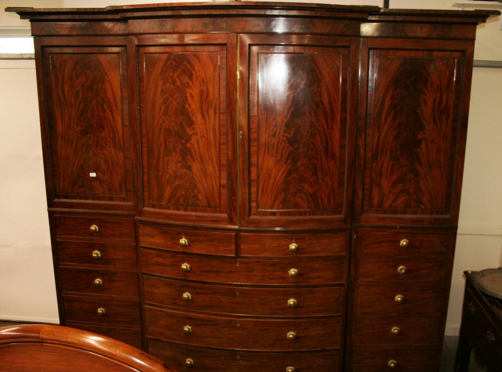 An early 19th Century mahogany bow fronted breakfront wardrobe, surmounted by a stepped cornice, - Image 2 of 3