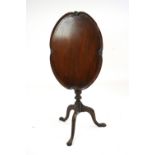 A mahogany occasional table, in the George III style, having a shaped tilt top,