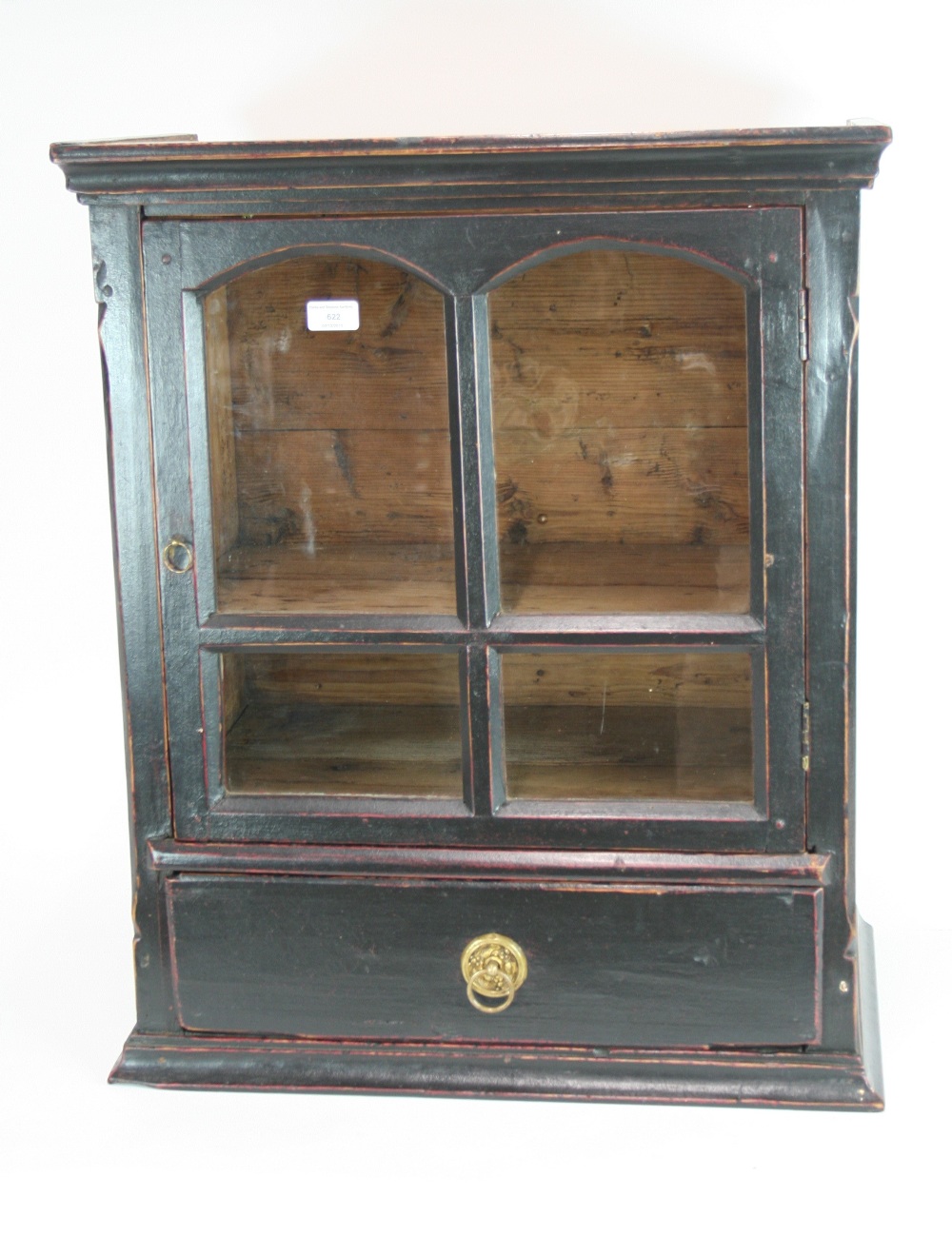 An 18th Century pine wall cupboard, the interior shelves enclosed by a glazed panelled door,