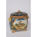 A Faience ware oval jar and cover, flanked by lion mask handles, decorated with hunting scenes,