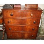 A Victorian mahogany chest, of four long drawers, fitted bun handles,