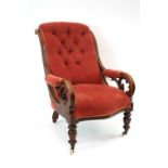 A Victorian mahogany framed armchair, with shaped button back, scrolled arms,