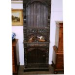 An unusual Antique carved oak bookcase, with figural, beast, foliate and fruit decoration,