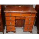 A 19th Century mahogany knee-hole desk, fitted brushing slide above a long drawer,