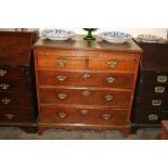 A George III oak chest, of two short and three long graduated drawers,
