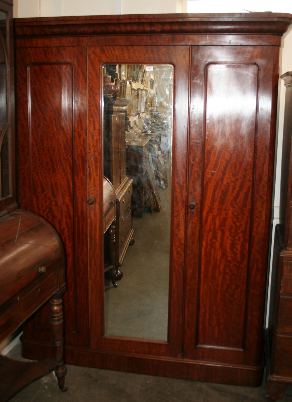 A Victorian mahogany triple wardrobe, fitted sliding trays,