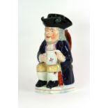 A 19th Century character jug, depicting a seated Toby Philpot, with foaming quart and pipe,