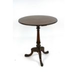 A 19th Century mahogany tripod occasional table, the circular top raised on a turned column,