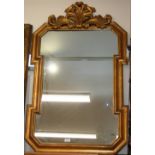 An 18th Century style gilt framed wall mirror, surmounted by a pierced foliate cresting,