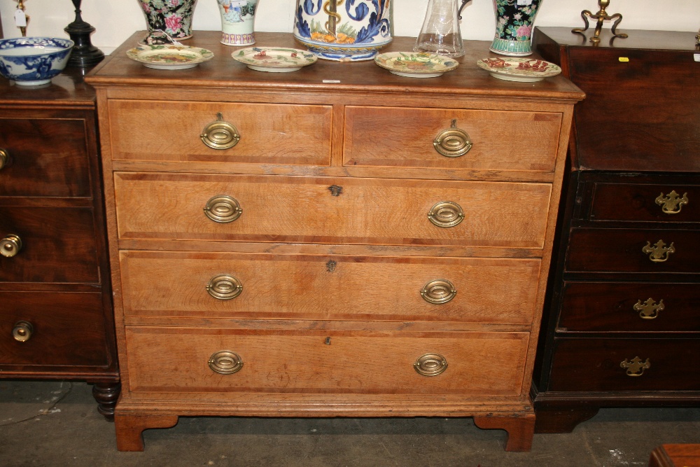 A Georgian oak, mahogany cross-banded and boxwood strung chest,