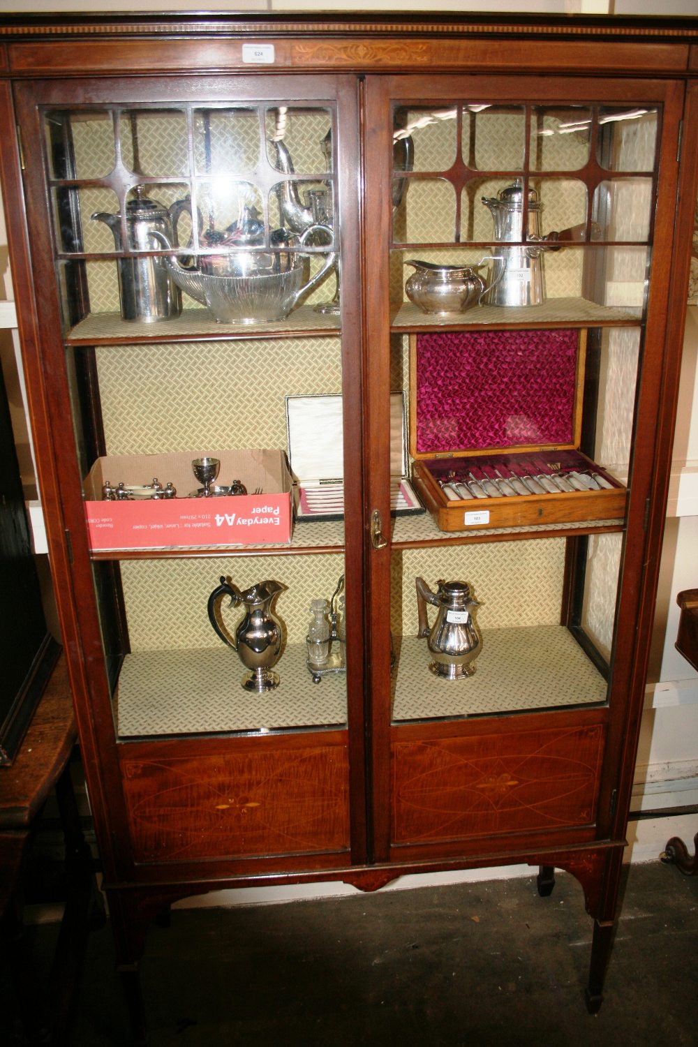 An Edwardian inlaid mahogany china display cabinet, enclosed by a pair of glazed panel doors,