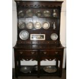 A good quality reproduction oak dresser, the shelved and boarded back fitted with six small drawers,
