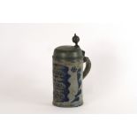 An antique German Westerwald pottery tankard, with domed pewter lid,