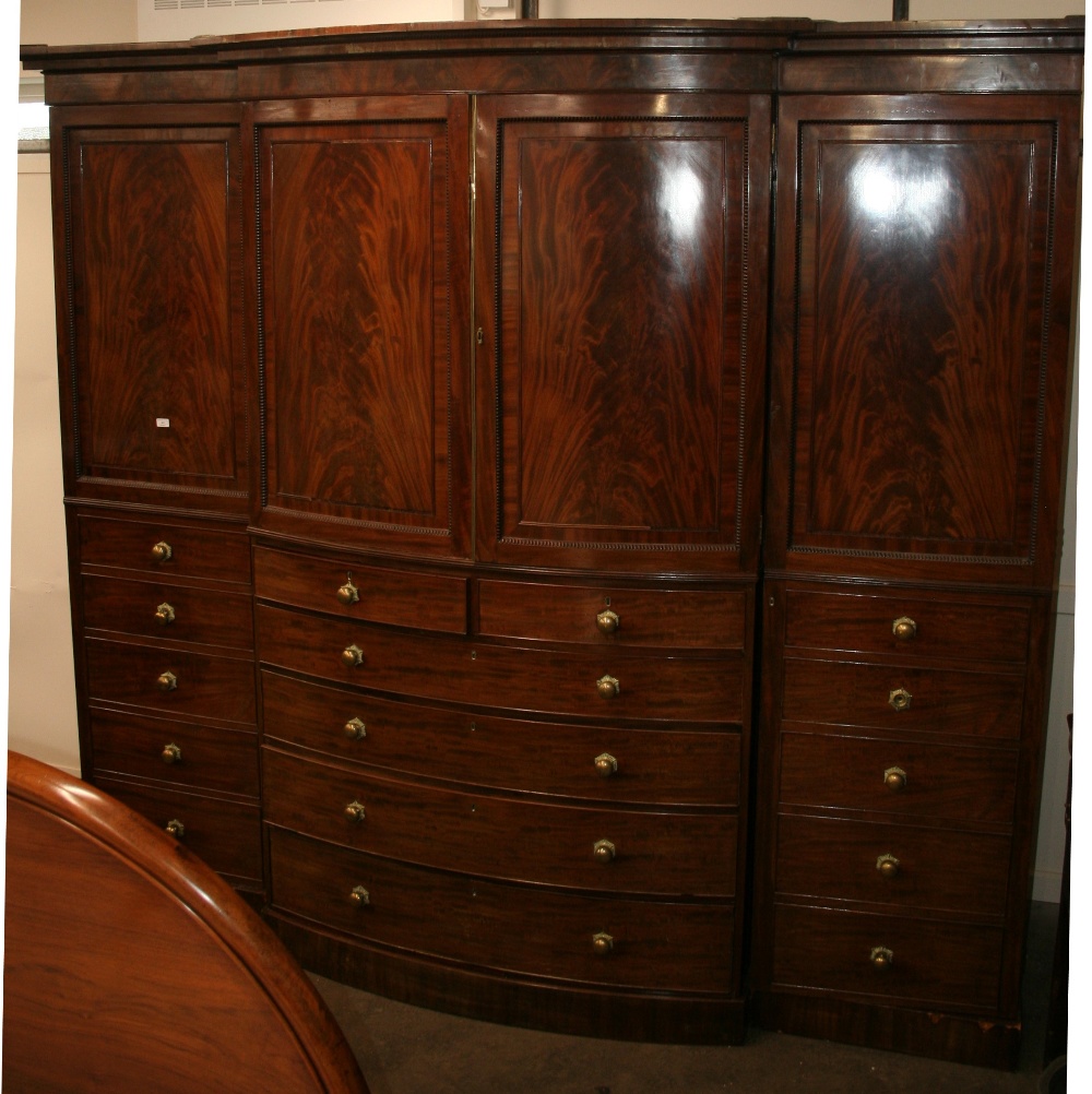 An early 19th Century mahogany bow fronted breakfront wardrobe, surmounted by a stepped cornice, - Image 3 of 3