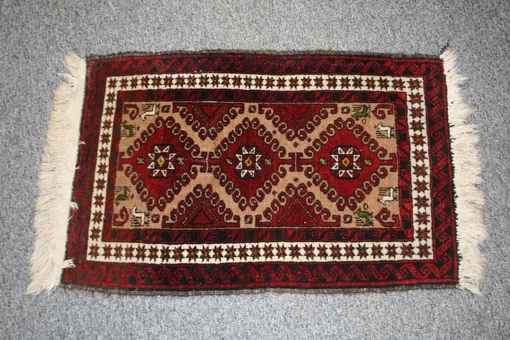 Two Eastern wool rugs, with stylised floral and and animal decoration on predominately red ground, - Image 2 of 3