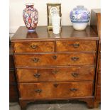 An 18th Century walnut chest, fitted two short and three long drawers, raised on bracket supports,