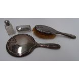 A silver backed hand mirror and brush wi