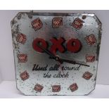 An OXO square electric wall clock.