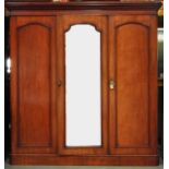 A Victorian mahogany wardrobe with moulded cornice and a mirror glazed full-length panelled door