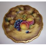 A Royal Worcester circular plate with shaped gilt gadroon rim, painted with fruit and signed J.