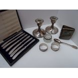 A pair of silver dwarf candlesticks, six