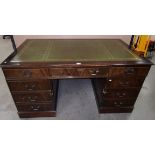 A reproduction mahogany eight drawer des