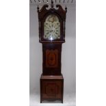 A long-case clock in a mahogany case wit