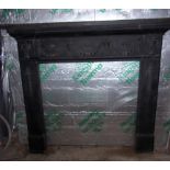 Black cast fireplace surround decorated