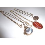 An oval 9ct gold fob pendant set with ov