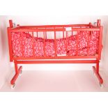 Red painted wooden dolls cot