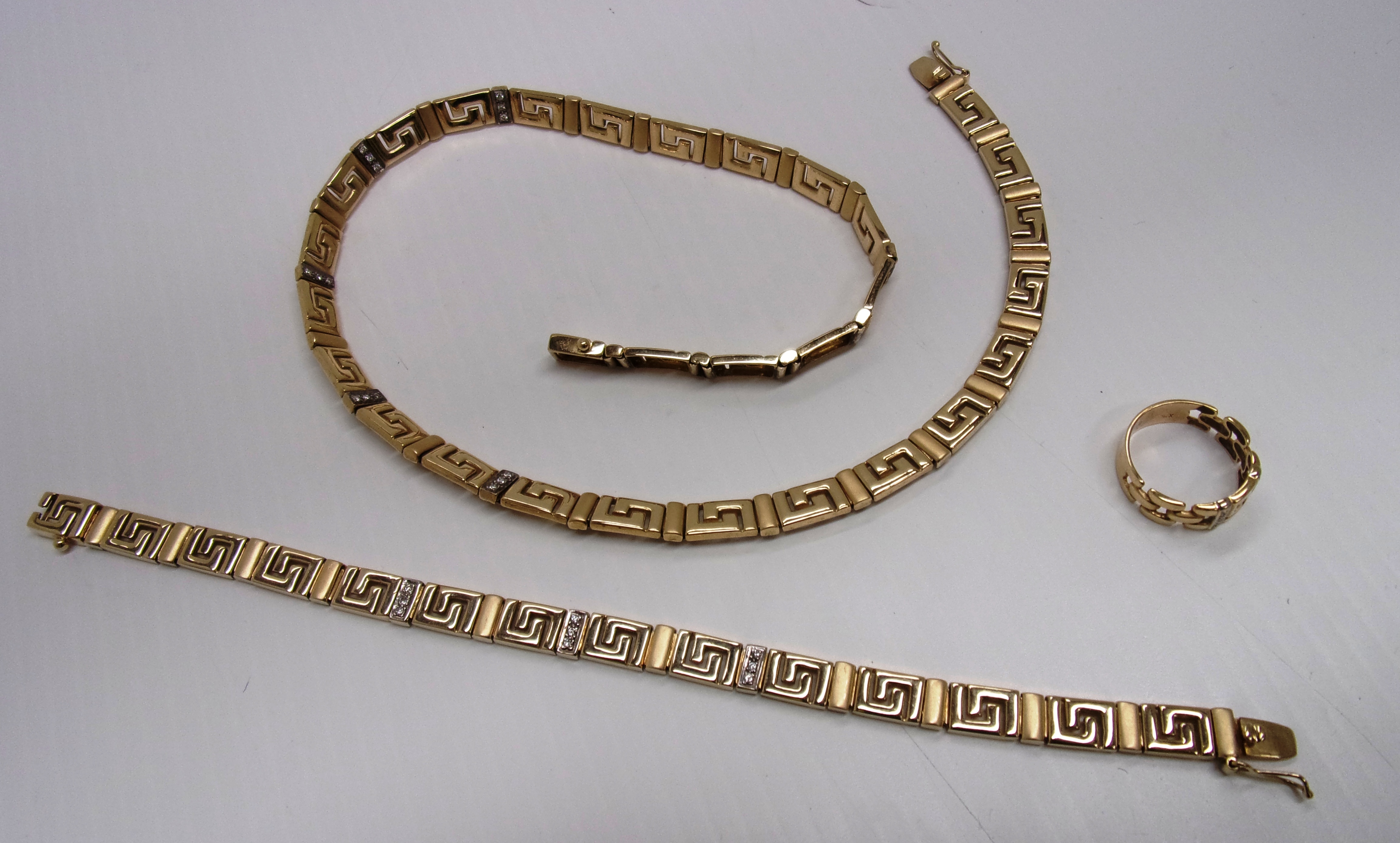 A necklace of key pattern panels with in