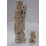 A carved ivory figure of a priest with a