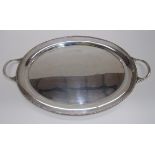 An oval silver tray with gadroon edge an