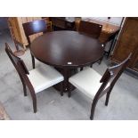 Dark oak finish circular dining table on