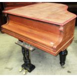 A Max Adolph grand piano, in a part-rest