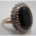 9ct white gold ring with oval dark blue stone surrounded by smaller stones 4.