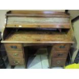 An oak roll top twin pedestal desk with 6 drawers