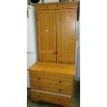 A pine finish 2 door wardrobe with matching chest of drawers