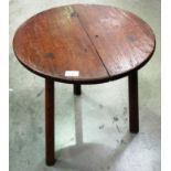 A circular oak cricket style occasional table on turned legs - 50 cm