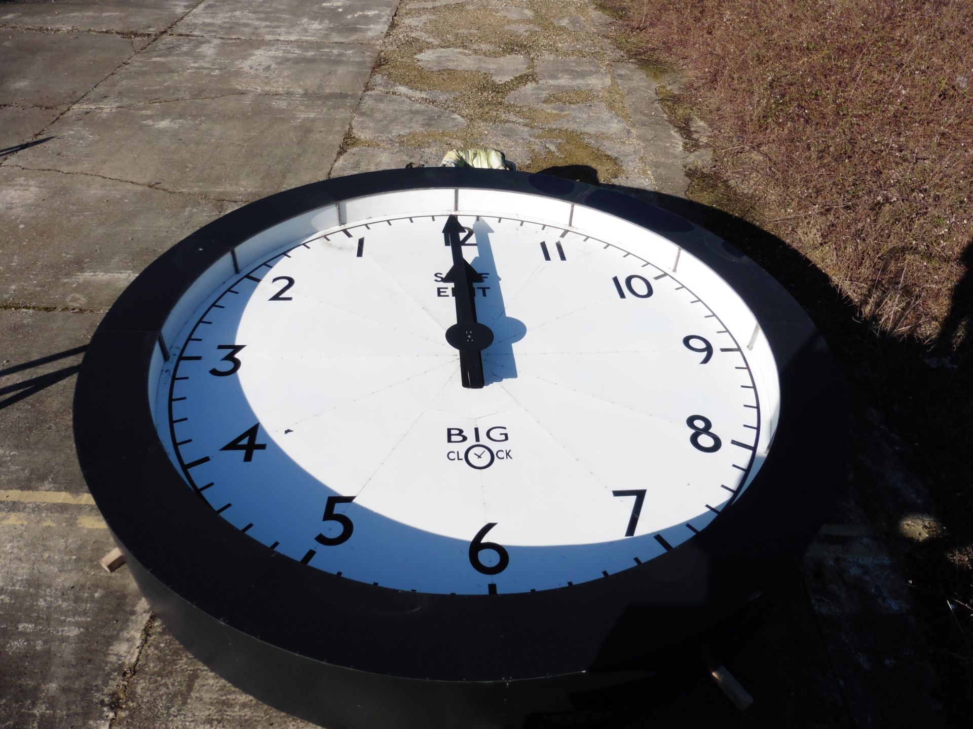 Large backwards clock with life-size man