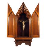 A 19th Century carved Ivory crucifix housed in an ornate Gothic style Oak case, crucifix height 9'',