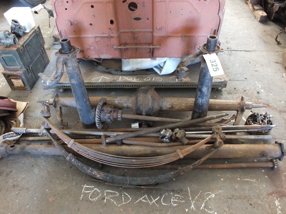 A group of Ford V8 parts including an ax