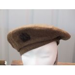 A WWII (dated 1945) beret with Bakelite