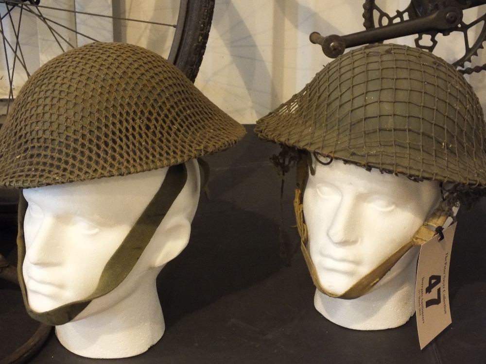 Two tin helmets one dated 1941